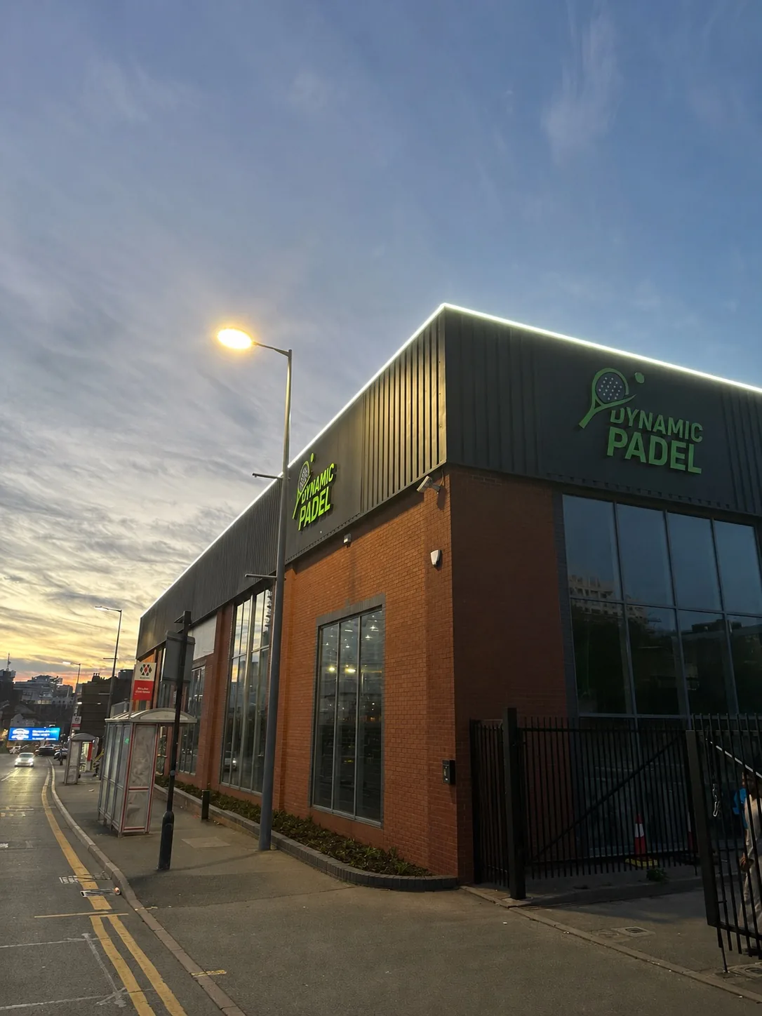 Building photo: the Dynamic Padel club building on High Street at dusk