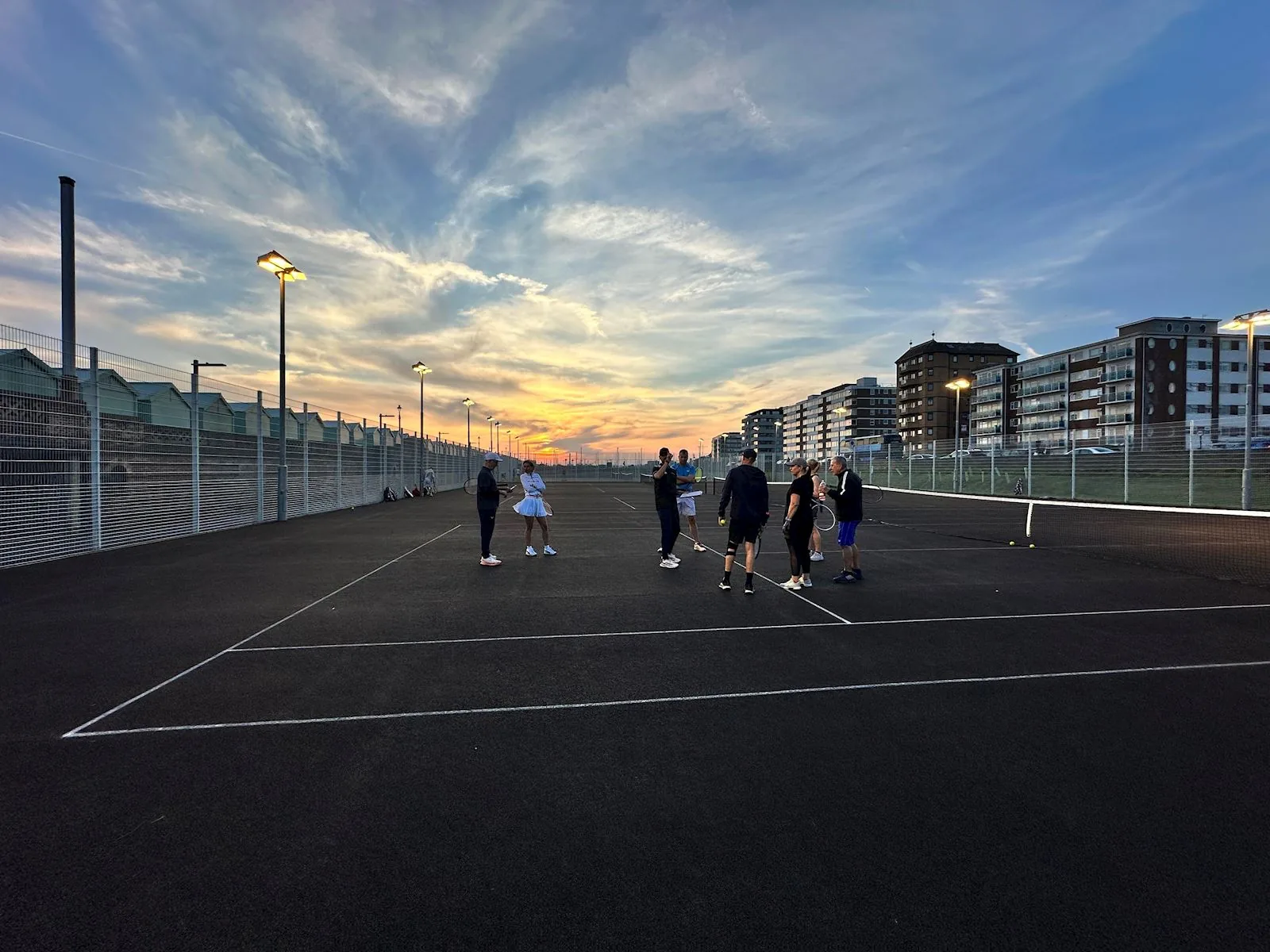 Outdoor hard courts at Game4Padel Hove Beach Park at dusk