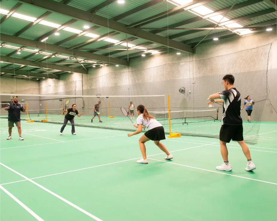 Players on the indoor badminton courts at Northside Badminton Centre