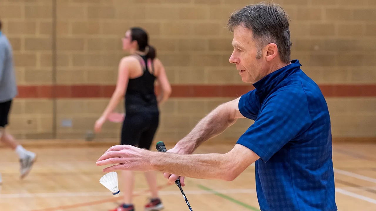 Badminton in the sports hall at Hills Road Sports & Tennis Centre