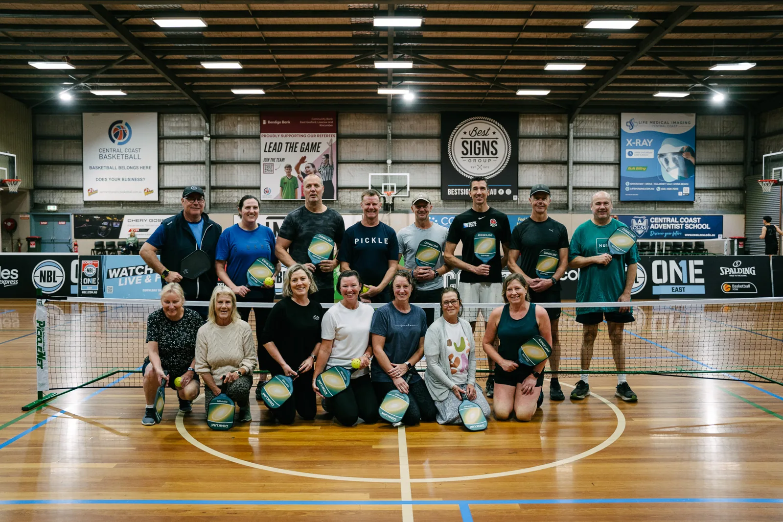 Players on an indoor court at Terrigal Pickleball, Guzman y Gomez Stadium