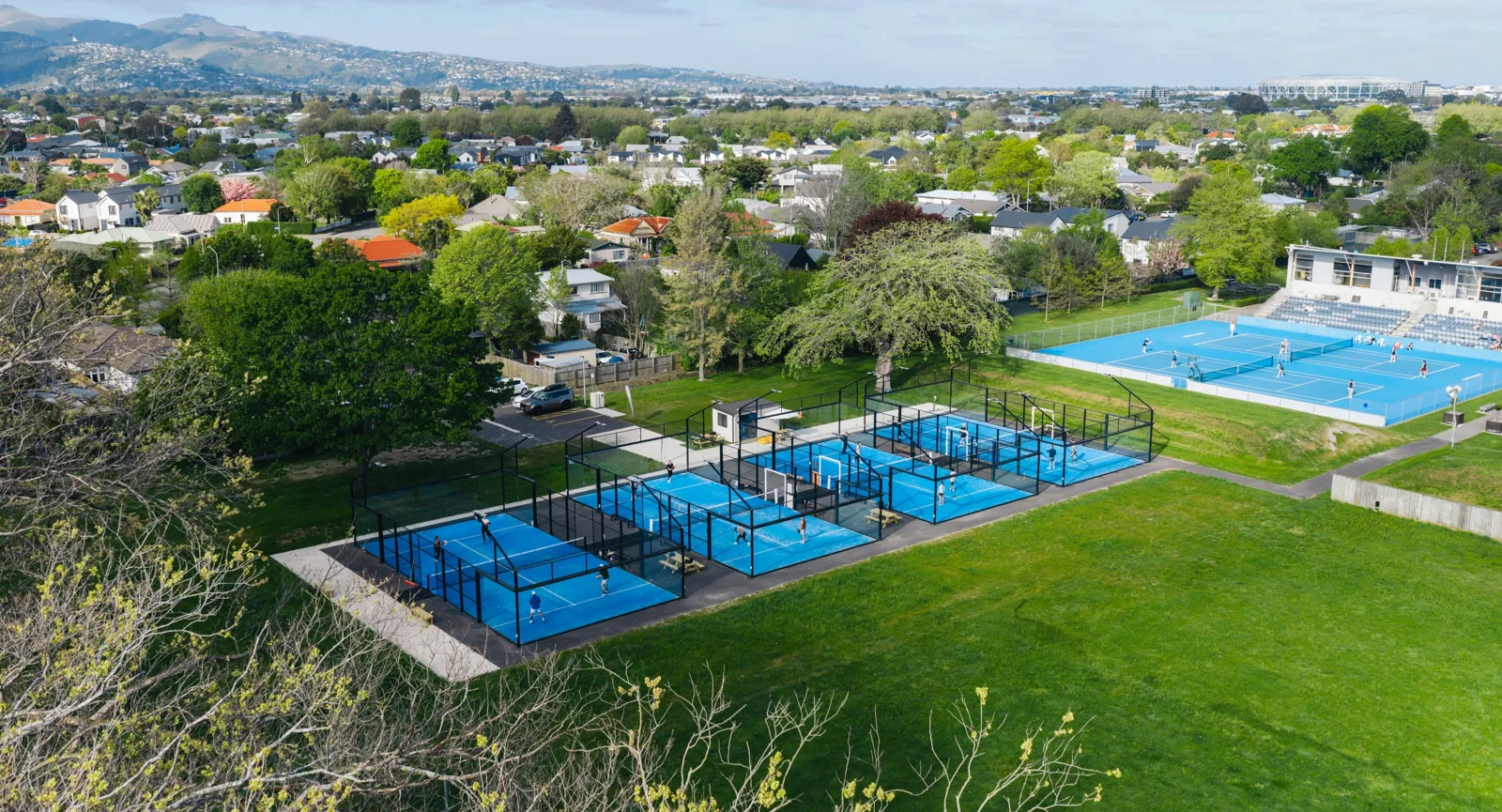Aerial view of the four outdoor padel courts at Pacific Padel Wilding Park