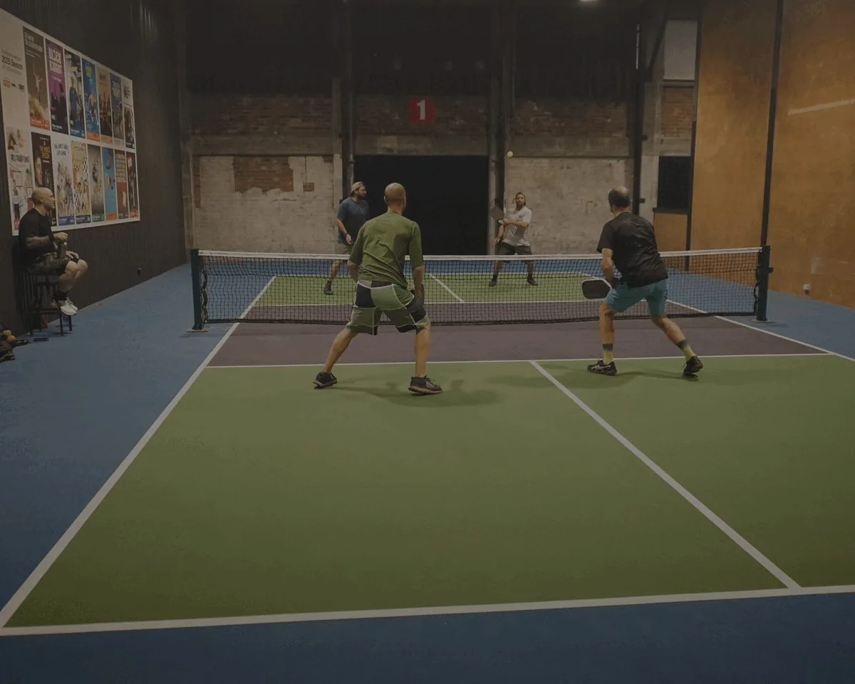Doubles game on an indoor court at picklepadel