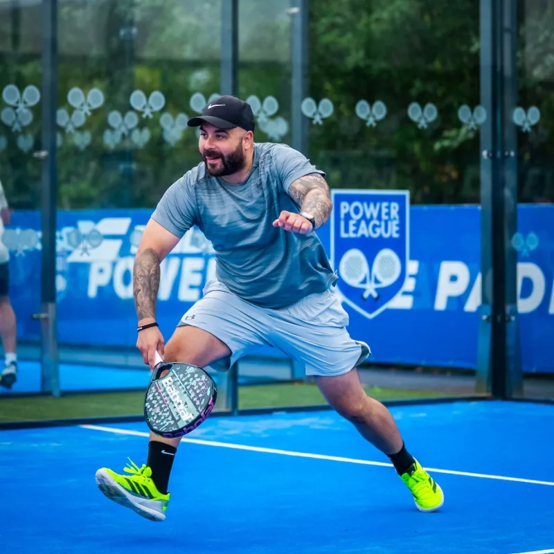 Padel player on a court at Powerleague Portobello