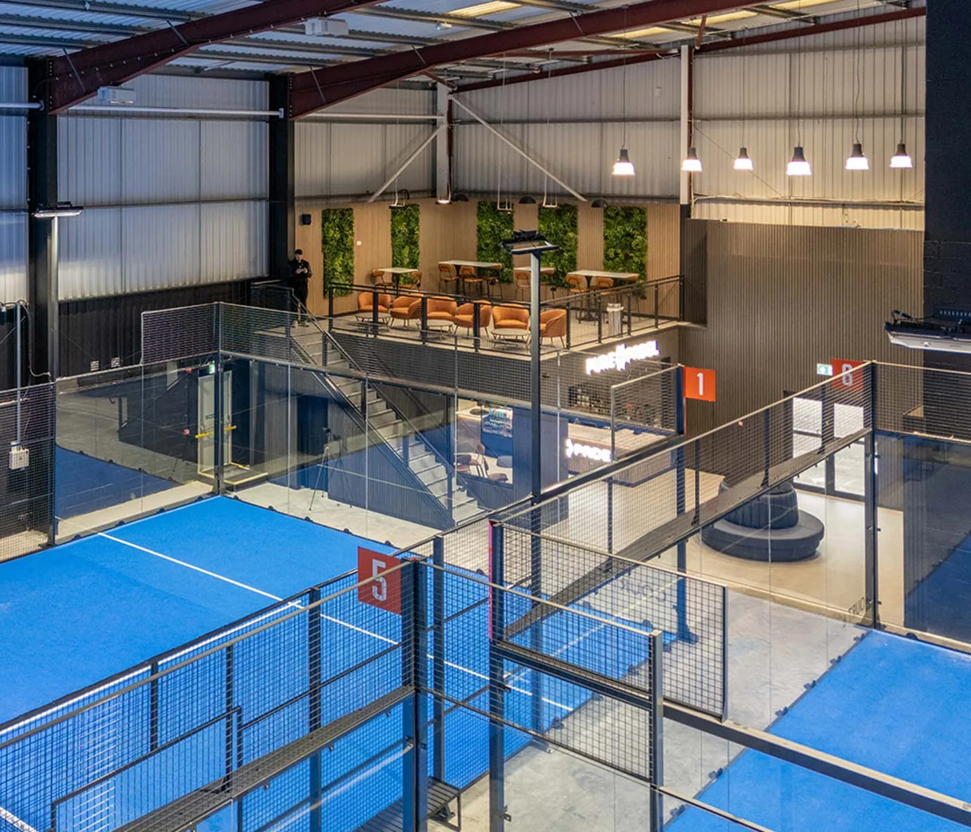 Courts and clubhouse balcony at Pure Padel Manchester