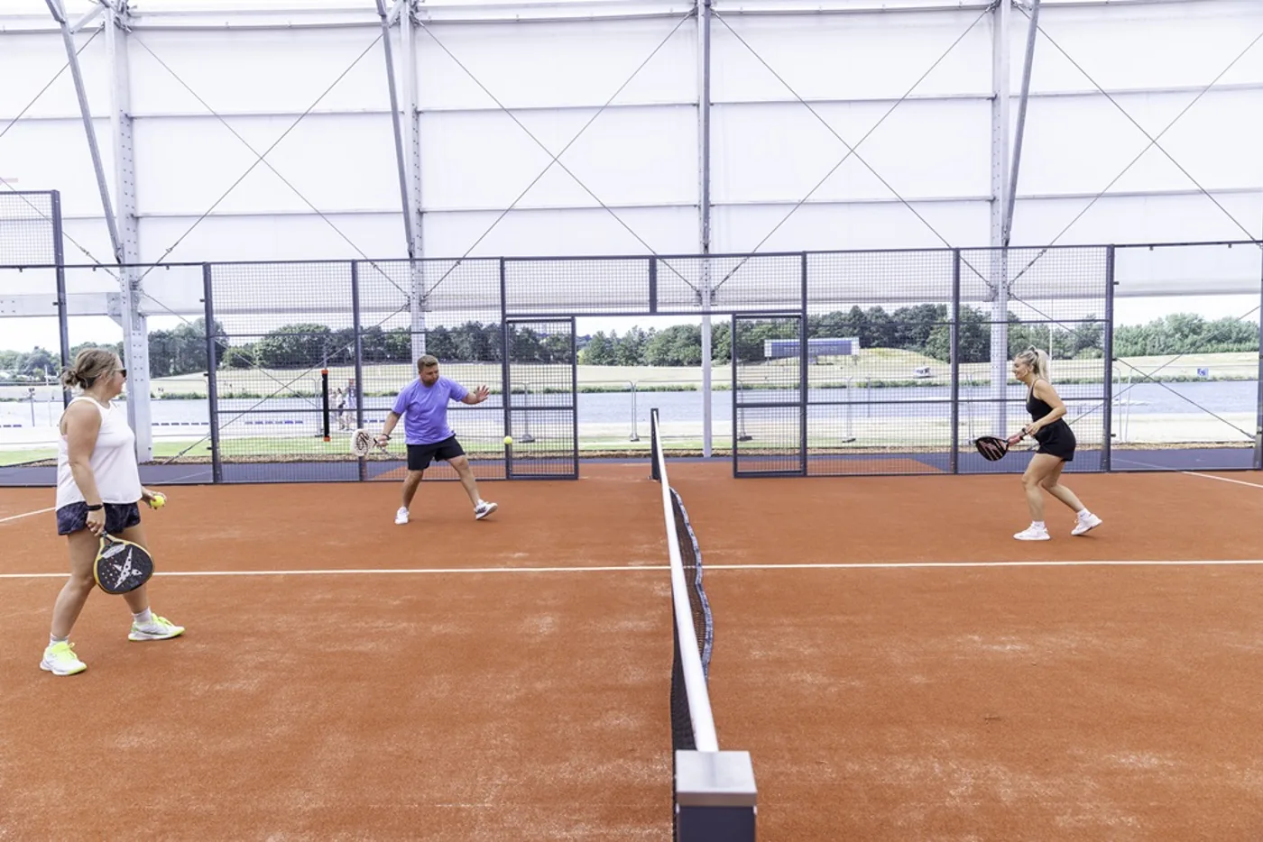 Players on a covered padel court at Barrio Padel, Holme Pierrepont