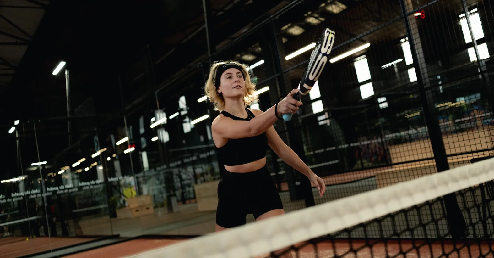 Player on an indoor padel court at Club de Padel Sheffield