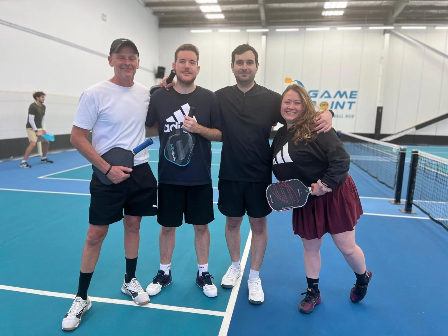 Players on the indoor pickleball courts at Game Point Coniston